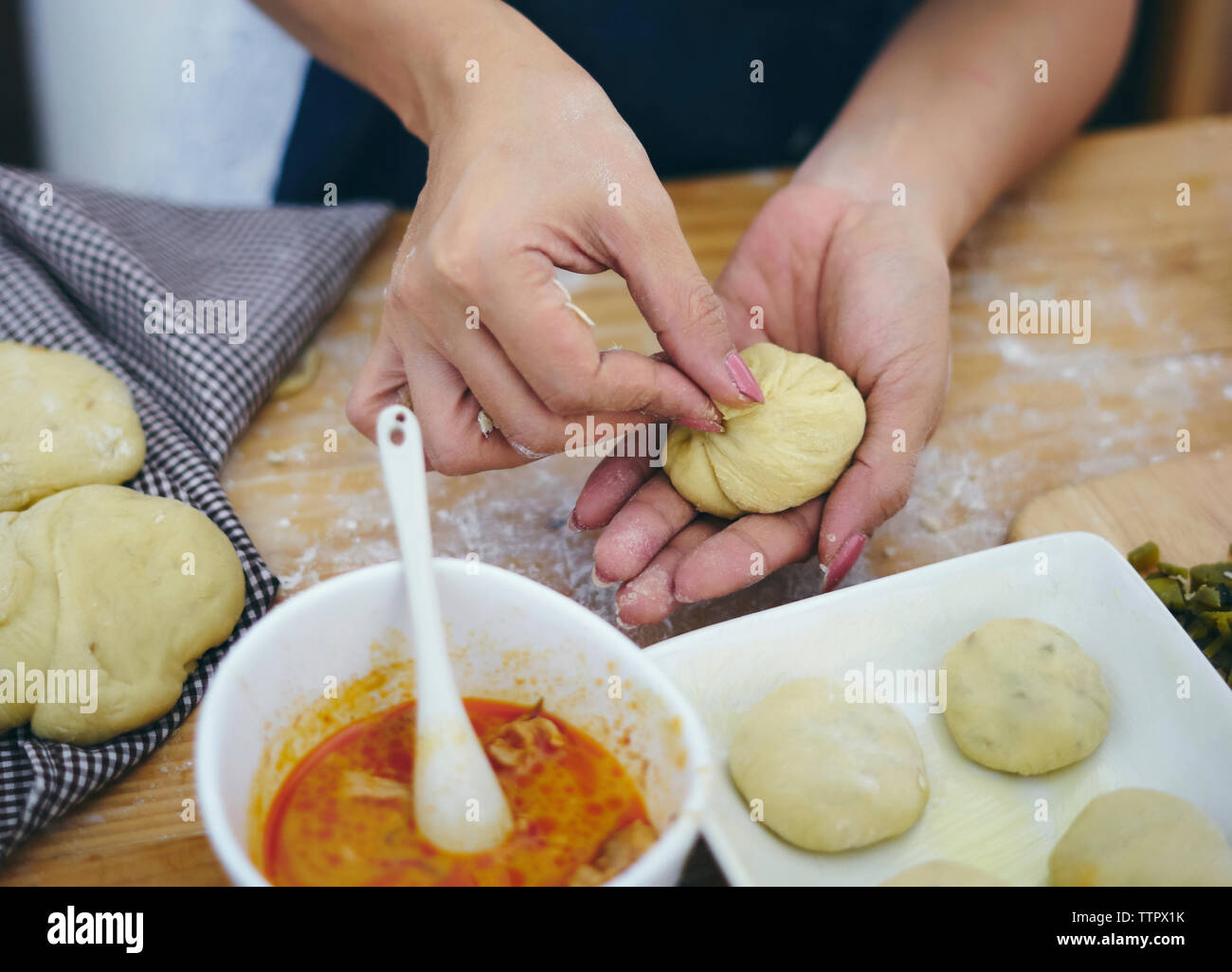 Cropped hands of woman preparing food at kitchen Stock Photo