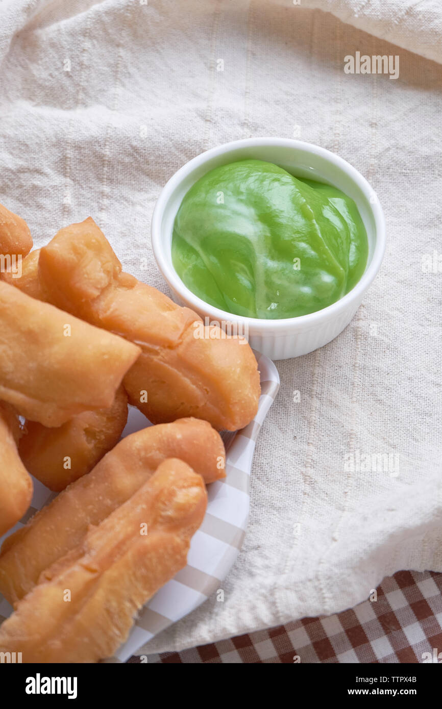 Close-up of deep fried food with pandan custard on tablecloth Stock Photo