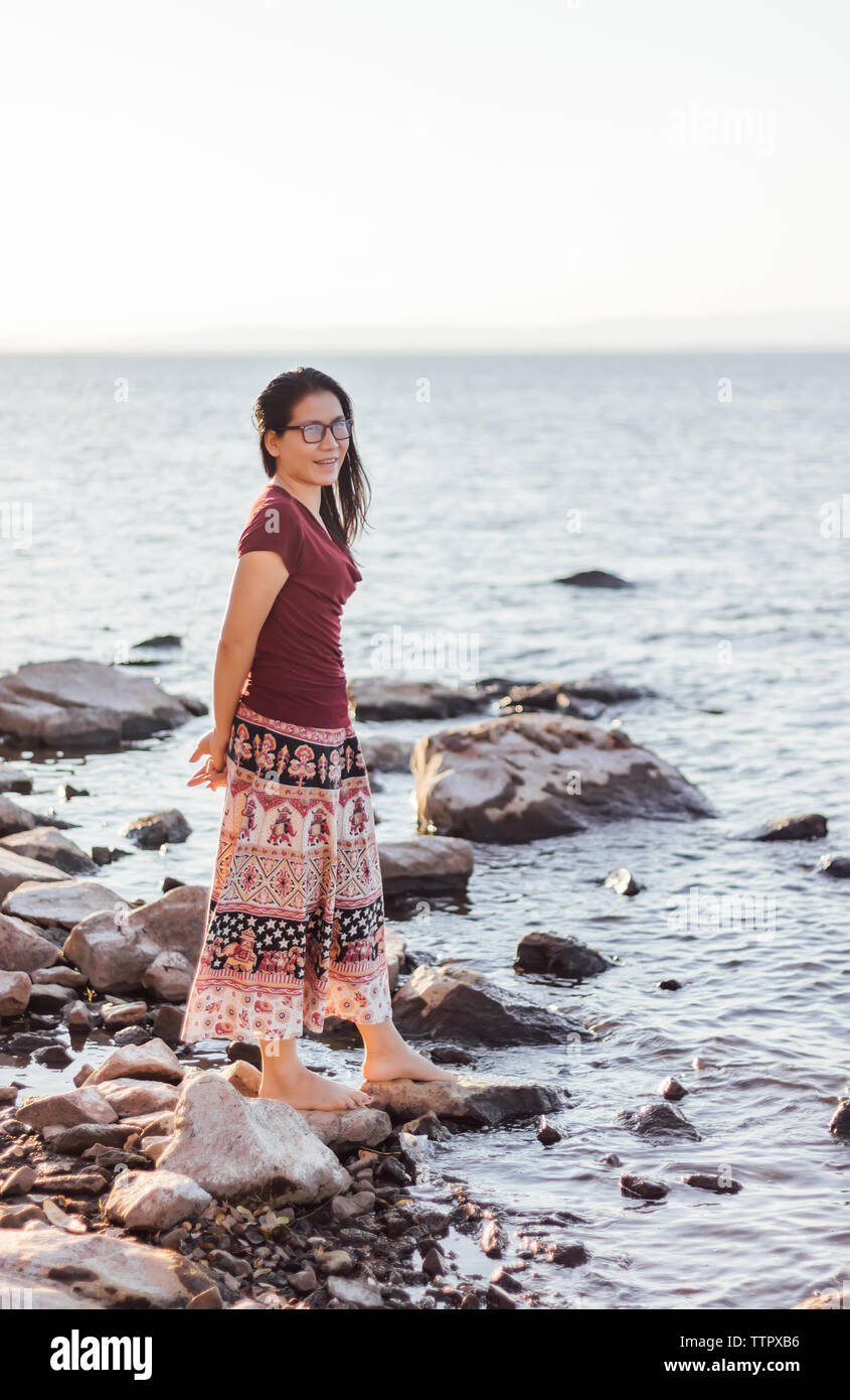 Woman standing on the rocks hi-res stock photography and images - Alamy