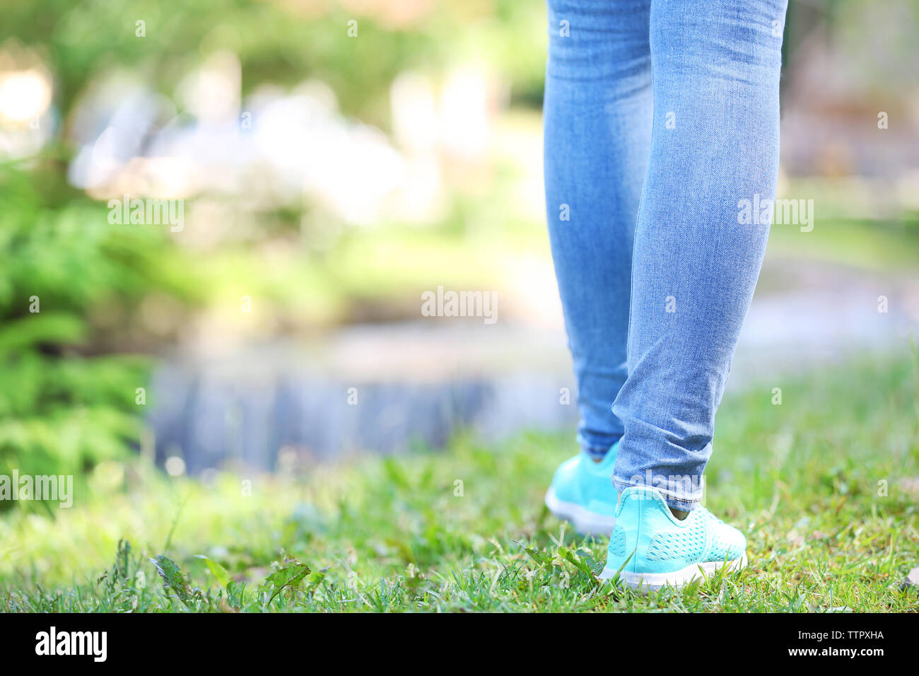 Young woman walking in the forest Stock Photo - Alamy