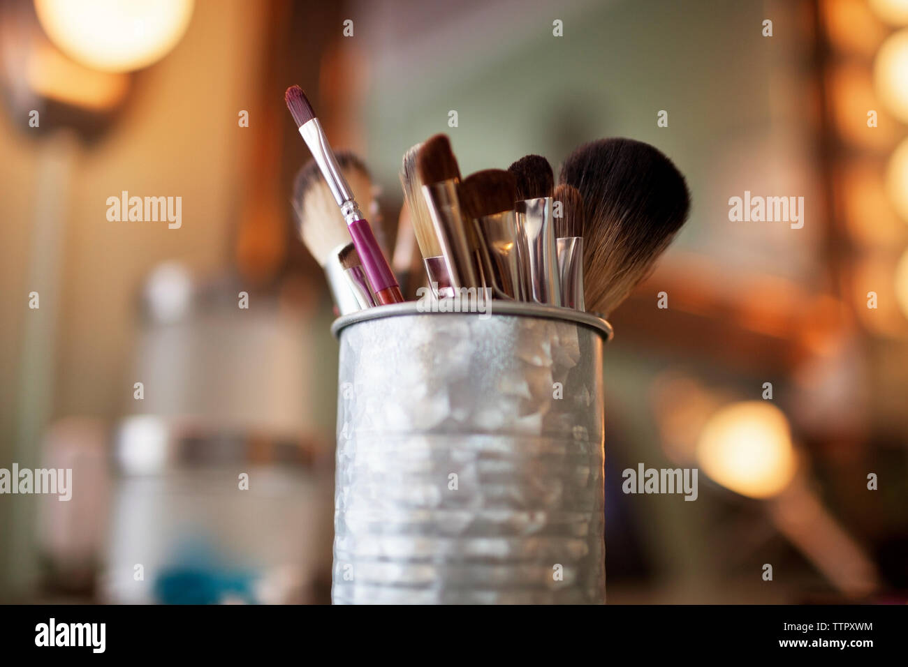 Makeup brushes in container Stock Photo