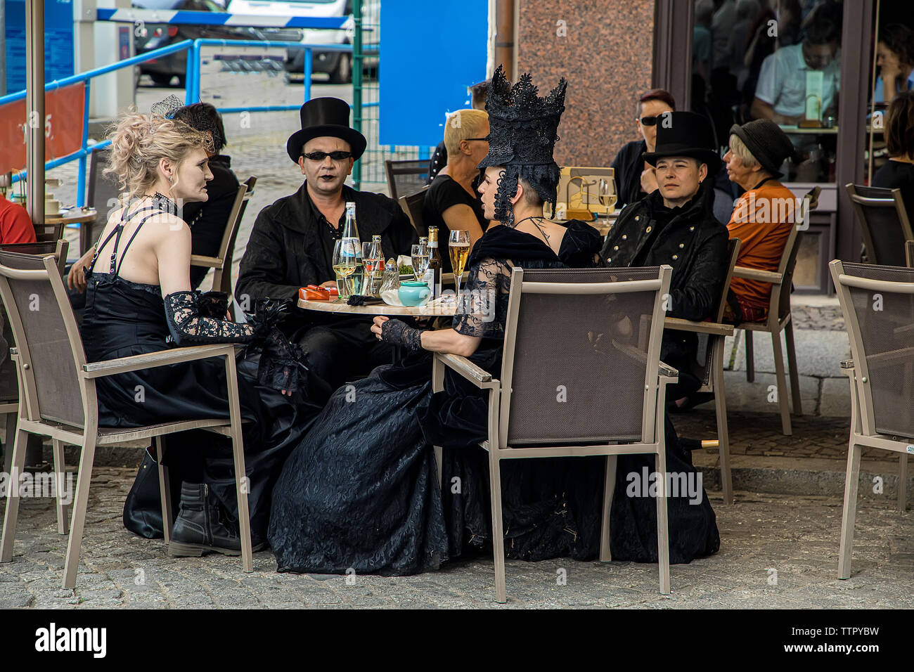 Leipzig, Germany , Juny 9, 2019 . Festive people in black and red gothic  and steampunk costumes at the street Stock Photo
