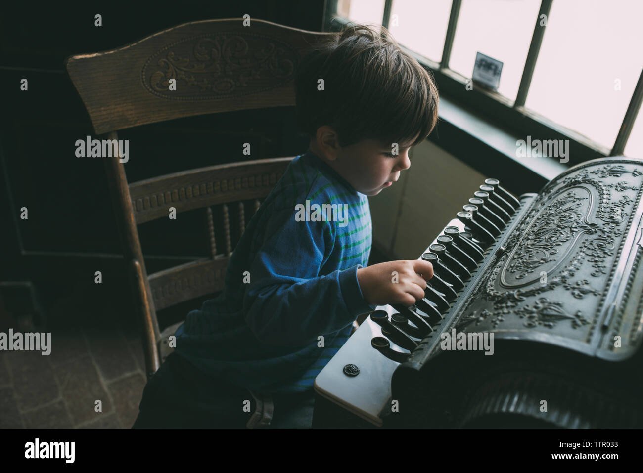 High angle view of boy playing musical instrument at home Stock Photo
