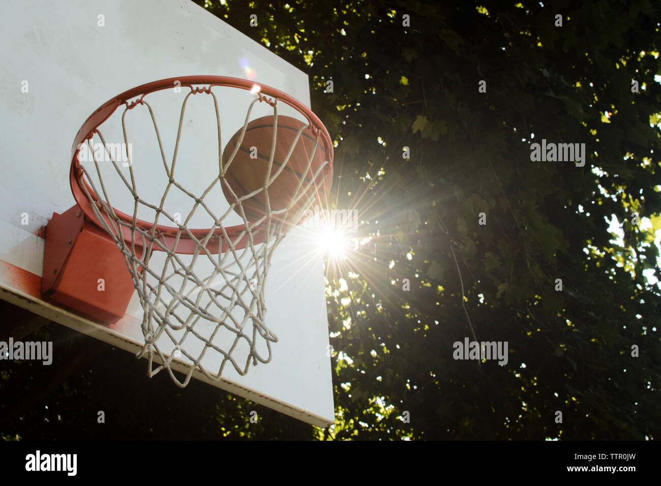 Low angle view of basketball in hoop Stock Photo