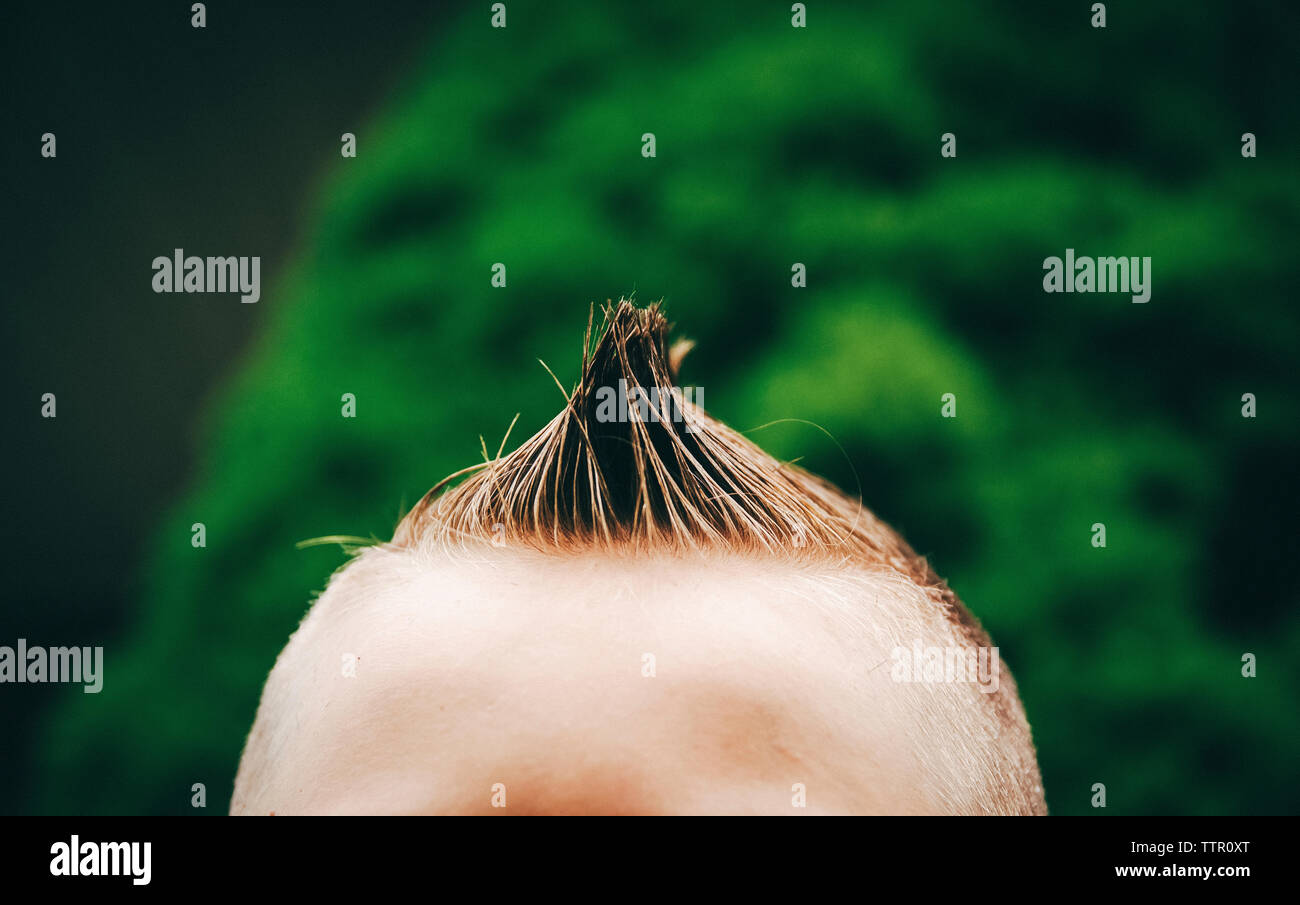 Close-up of boy with spiky hair Stock Photo