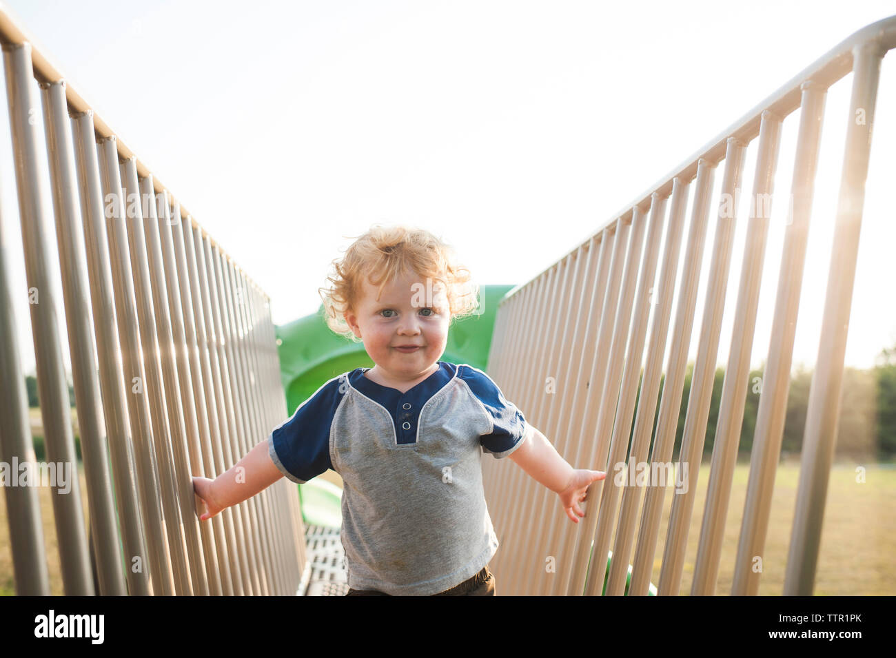 Portrait of cute baby boy playing on outdoor play equipment at playground Stock Photo