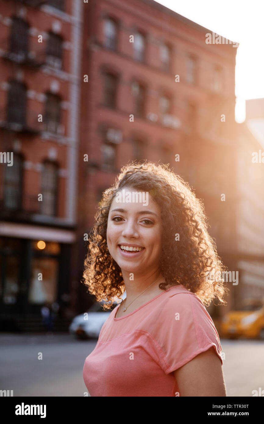 Portrait of happy businesswoman on city street Stock Photo