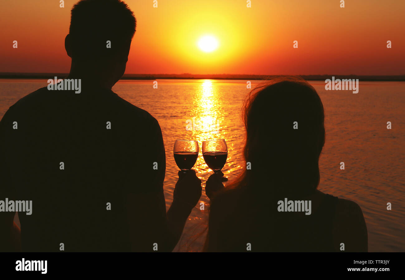 Silhouette couple drinking wine sunset hi-res stock photography and ...