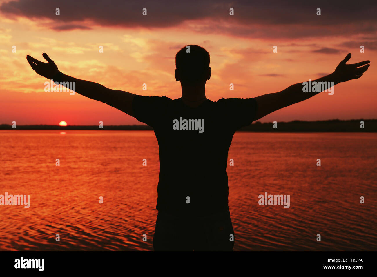 Silhouette of man on sunset sky background Stock Photo - Alamy