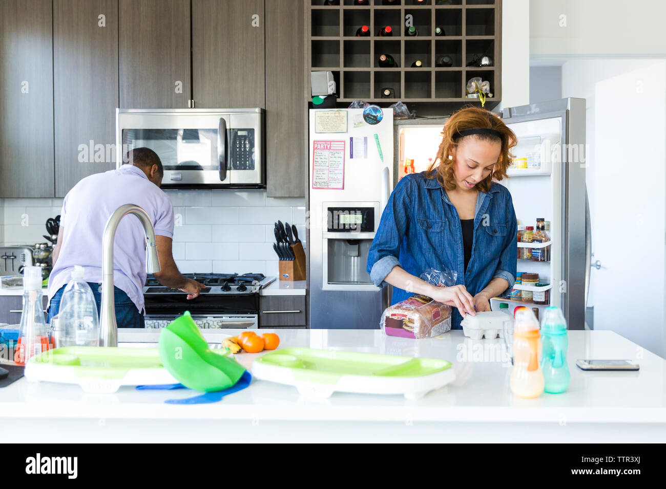 Couple working together in kitchen Stock Photo