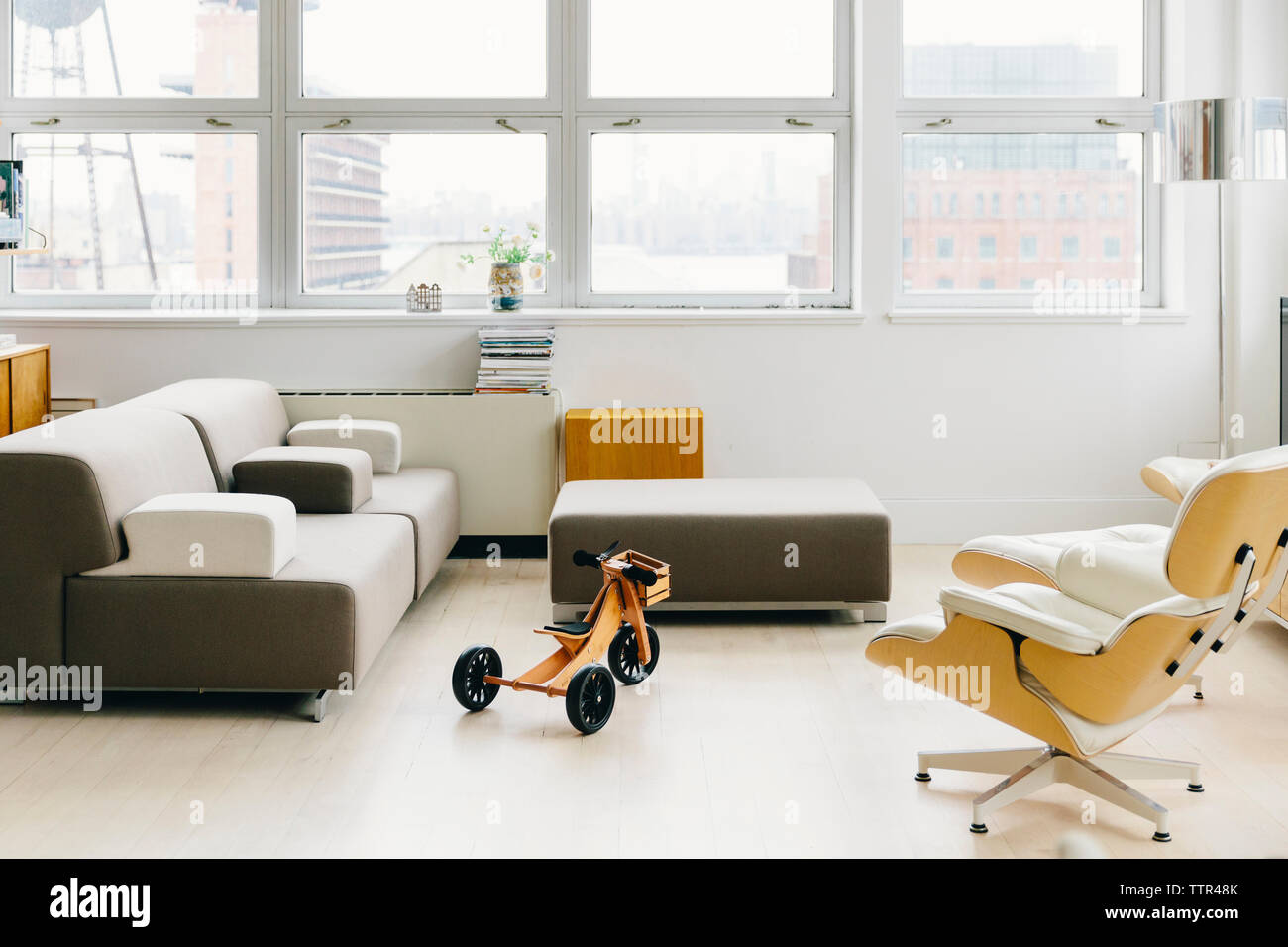 Furniture on hardwood floor against windows in startup office Stock Photo