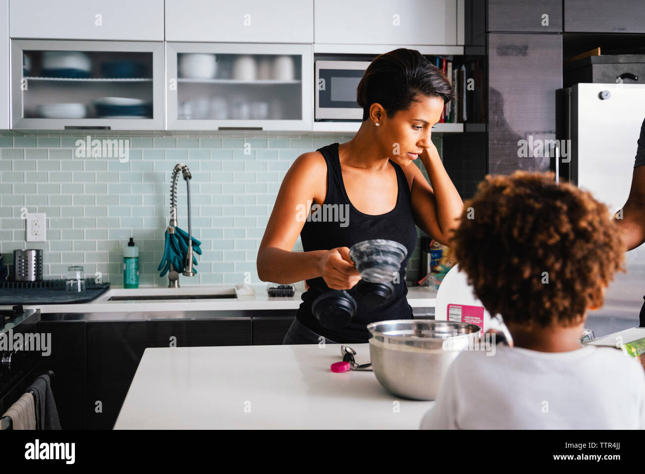 Mother with son preparing food in kitchen at home Stock Photo