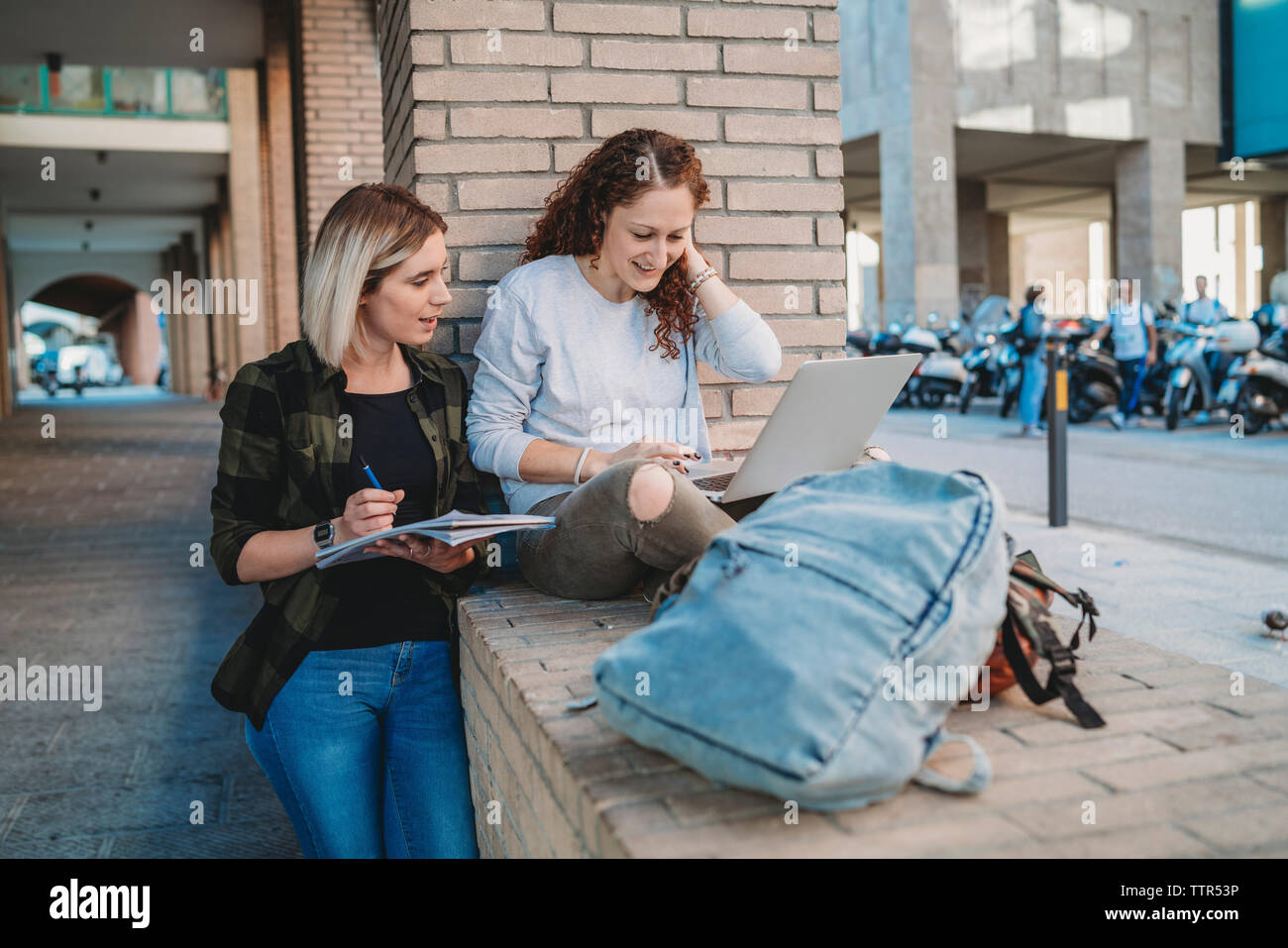 Two young students in the college using laptop Stock Photo