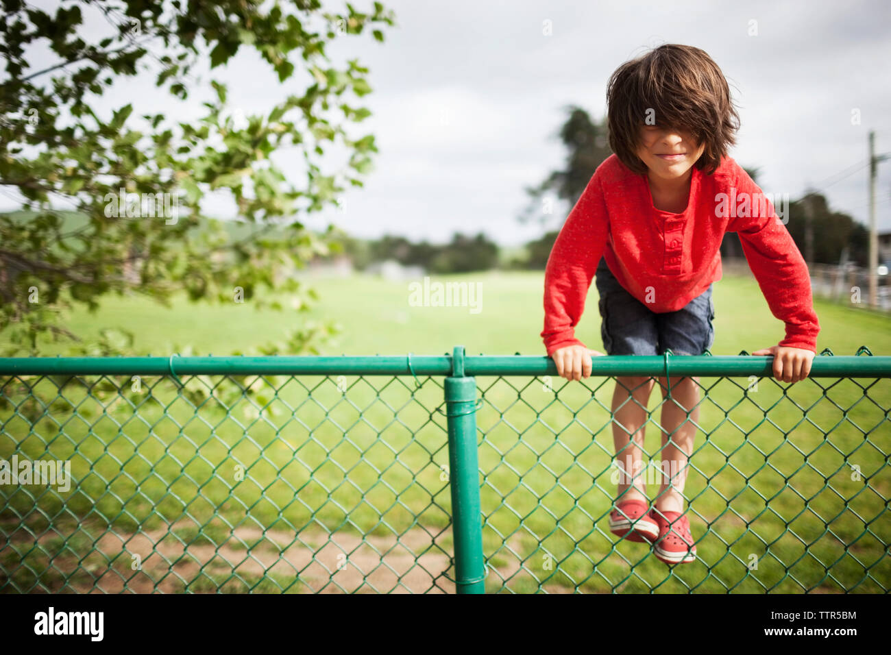 Person climbing fence hires stock photography and images Alamy