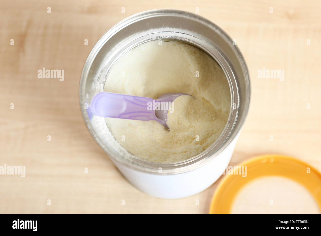 Baby milk formula in can on wooden background Stock Photo