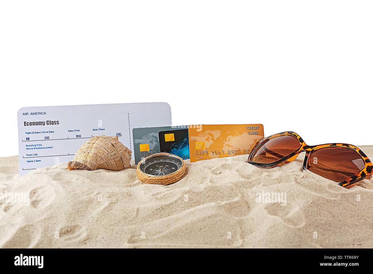 Credit cards and ticket on sand, white background Stock Photo