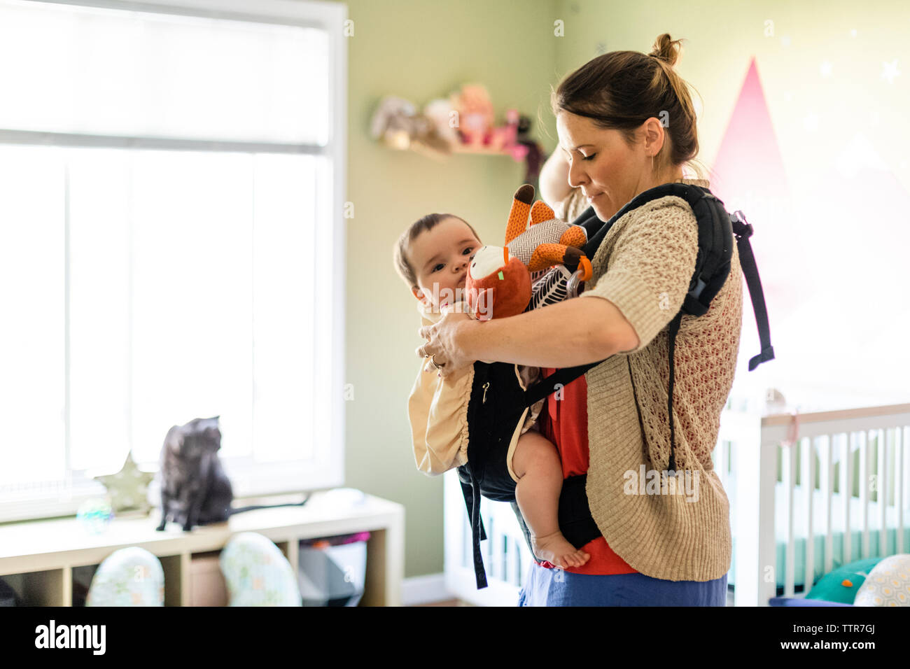 Mom with baby getting ready to leave daycare Stock Photo Alamy