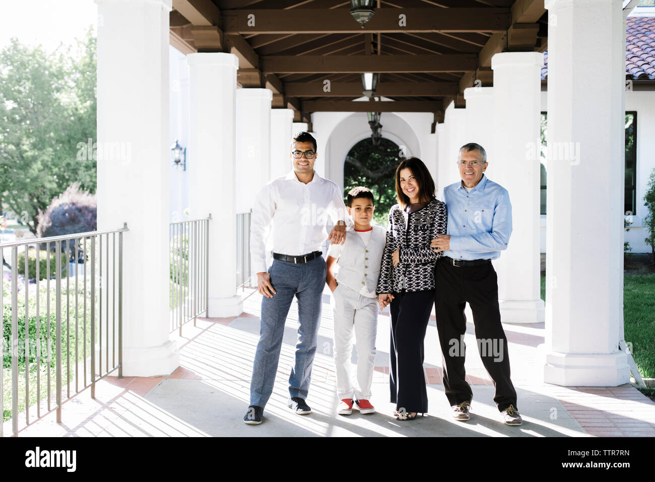 Portrait of elegant family by Spanish architecture colonnades Stock Photo