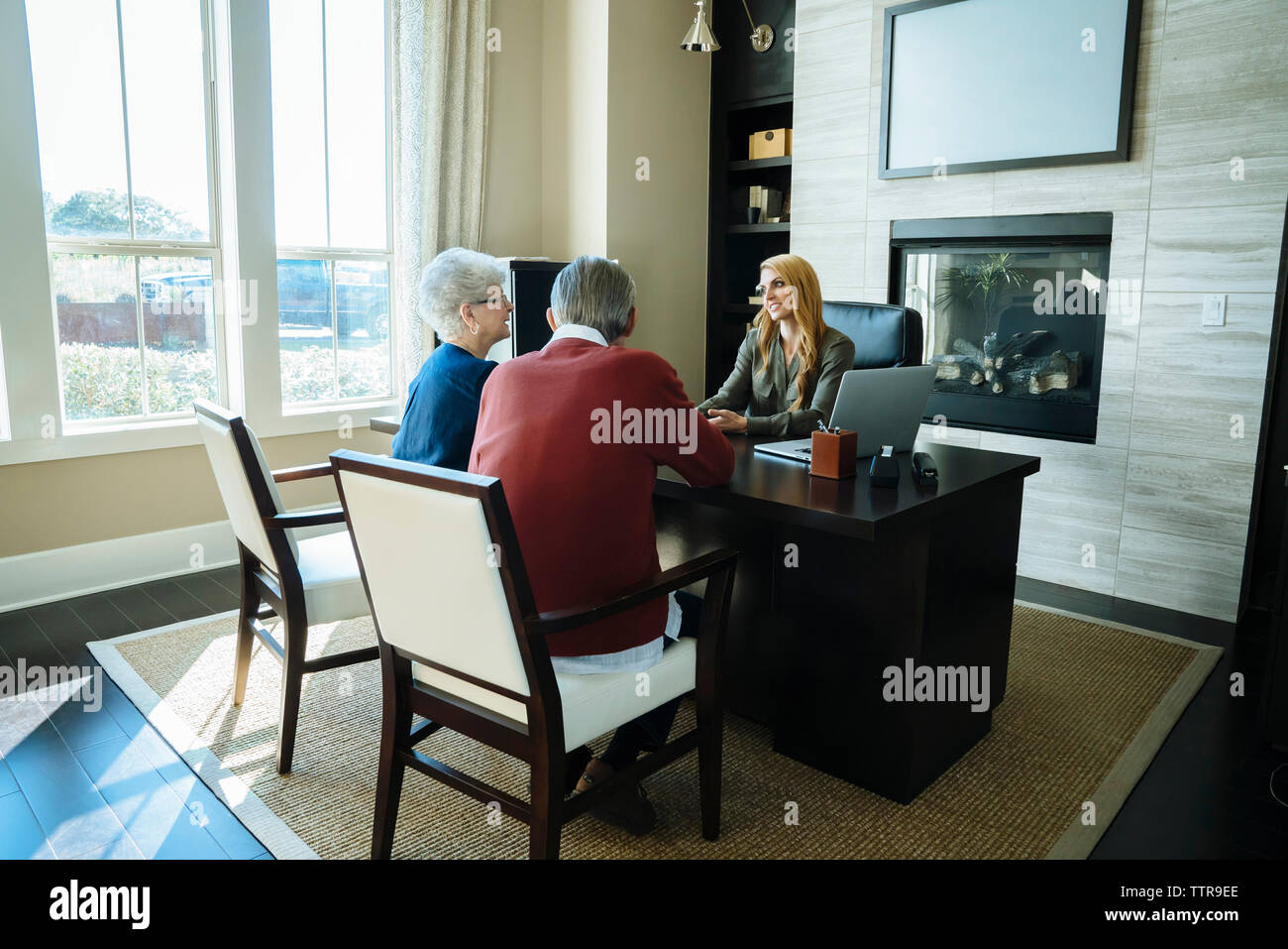 Senior Couple Discussing With Financial Advisor While