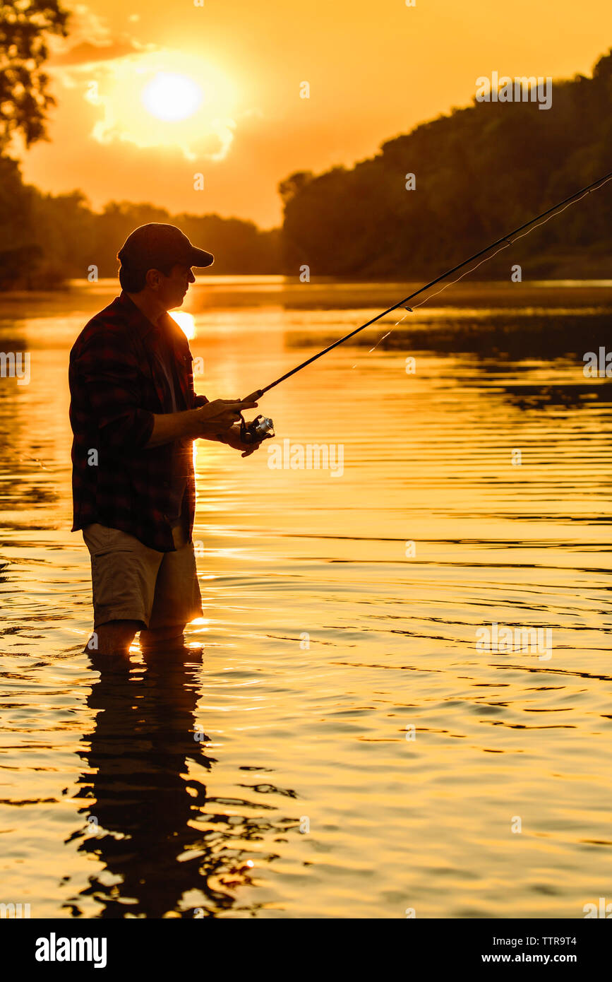 Young Man Flyfishing At Sunrise Stock Photo - Download Image Now