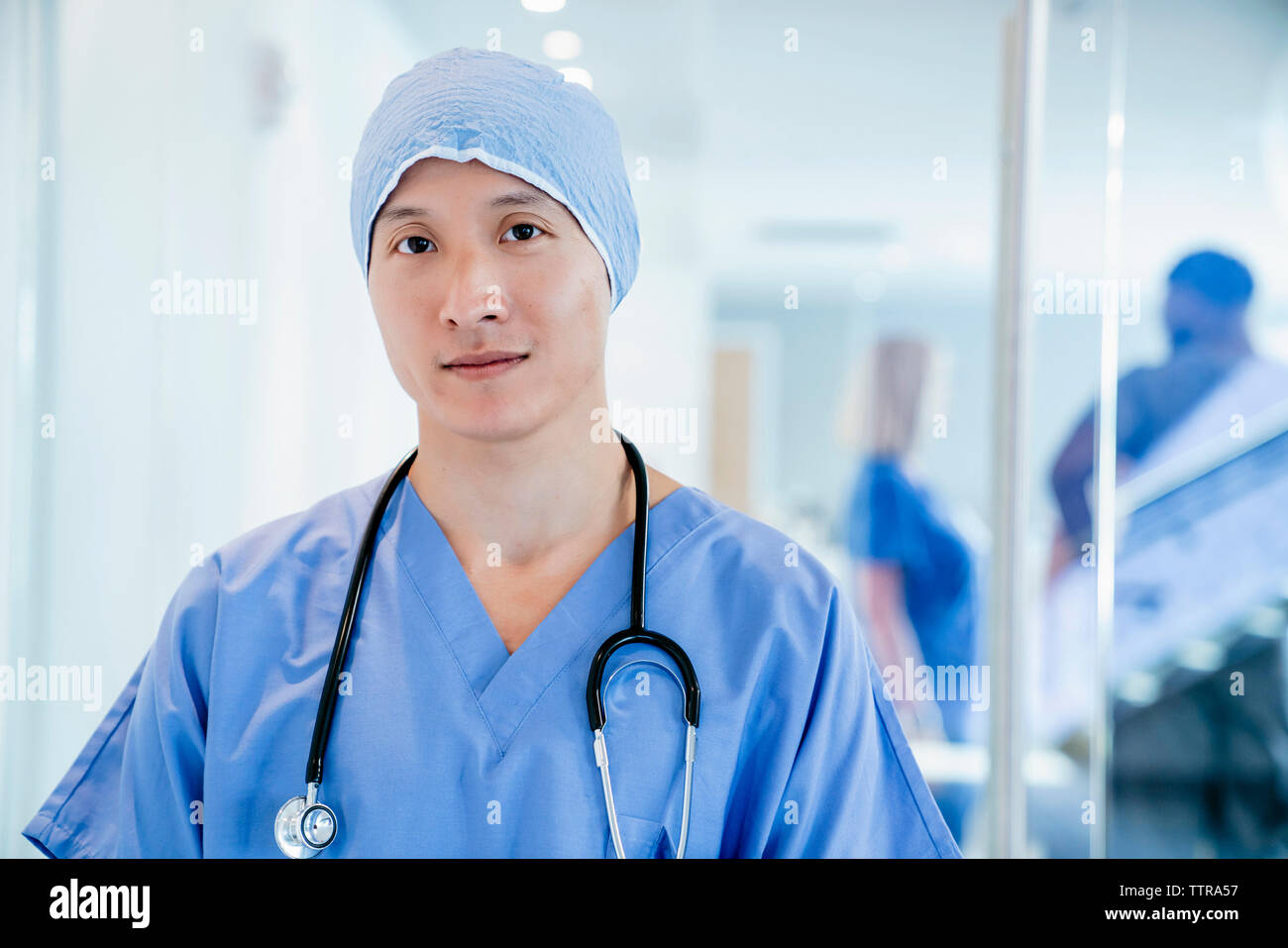 Portrait of confident surgeon wearing surgical cap in hospital Stock