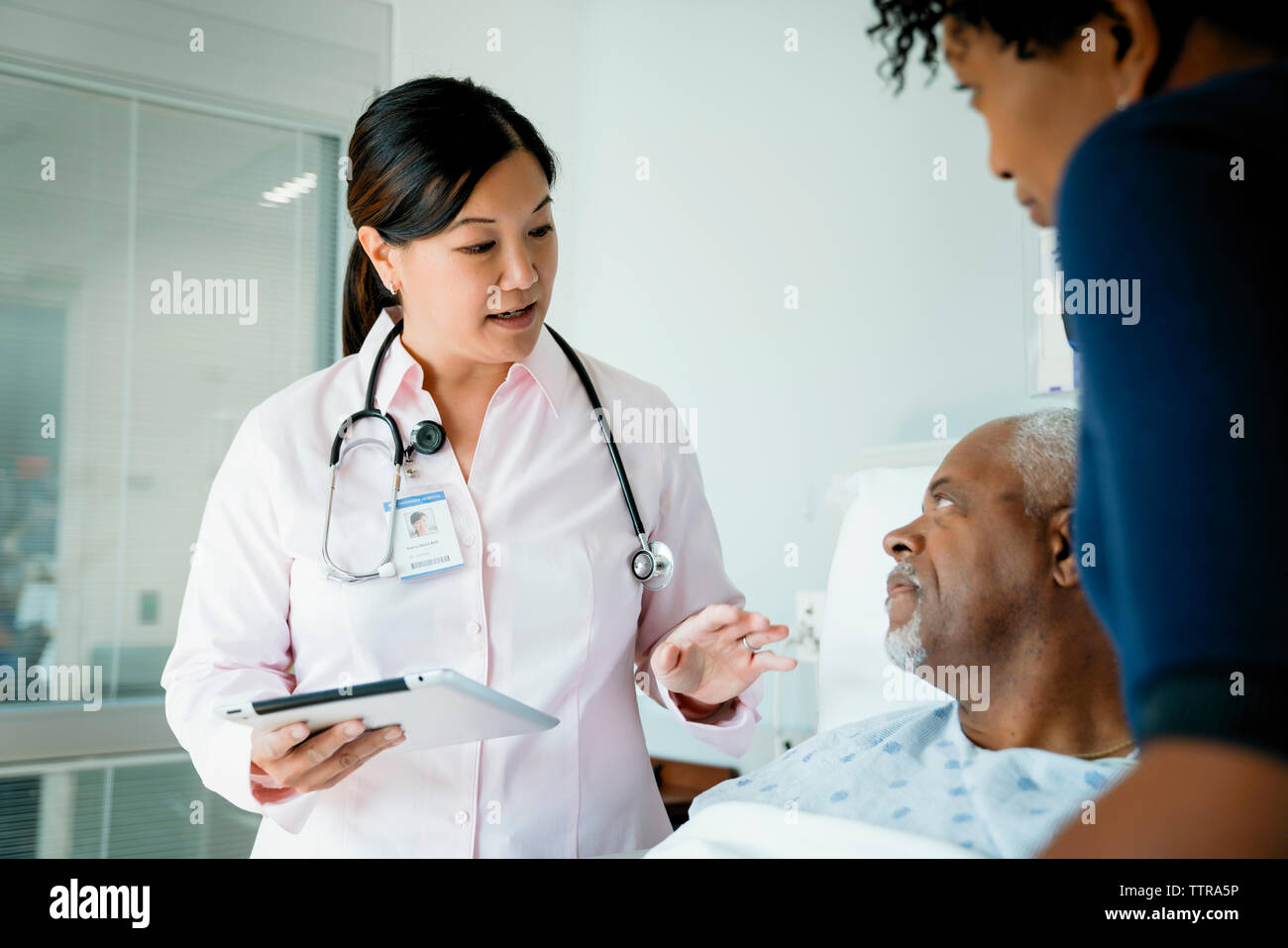 Doctor talking to patient family hi-res stock photography and images ...