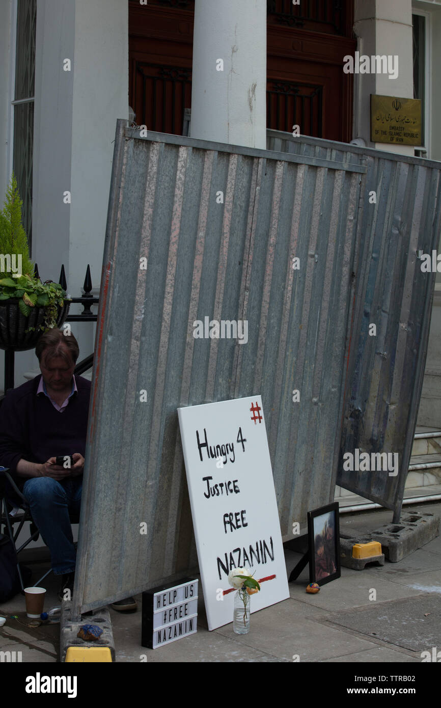 London, UK. 17th June 2019. Hunger striker Richard Ratcliffe behind an iron board, placed there by Iranian embassy staff and builders today, in front of the Iranian embassy in London protesting the detention of his wife Nazanin Zaghari in Iran over spying allegations. Credit: Joe Kuis / Alamy Stock Photo