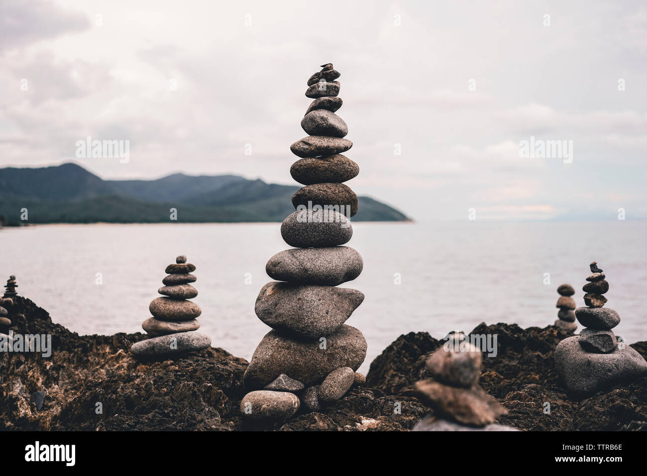 Close-up of stacked pebbles by sea at Borderline Beach Stock Photo