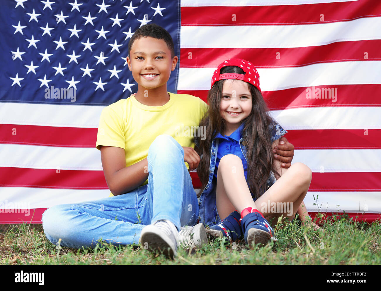 Boy and girl on American flag background Stock Photo - Alamy