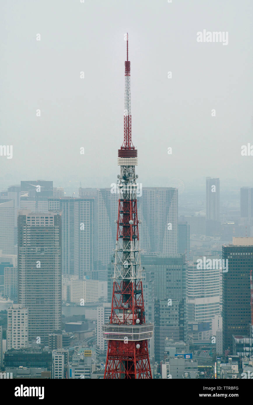 High section of Tokyo Tower in city against sky Stock Photo