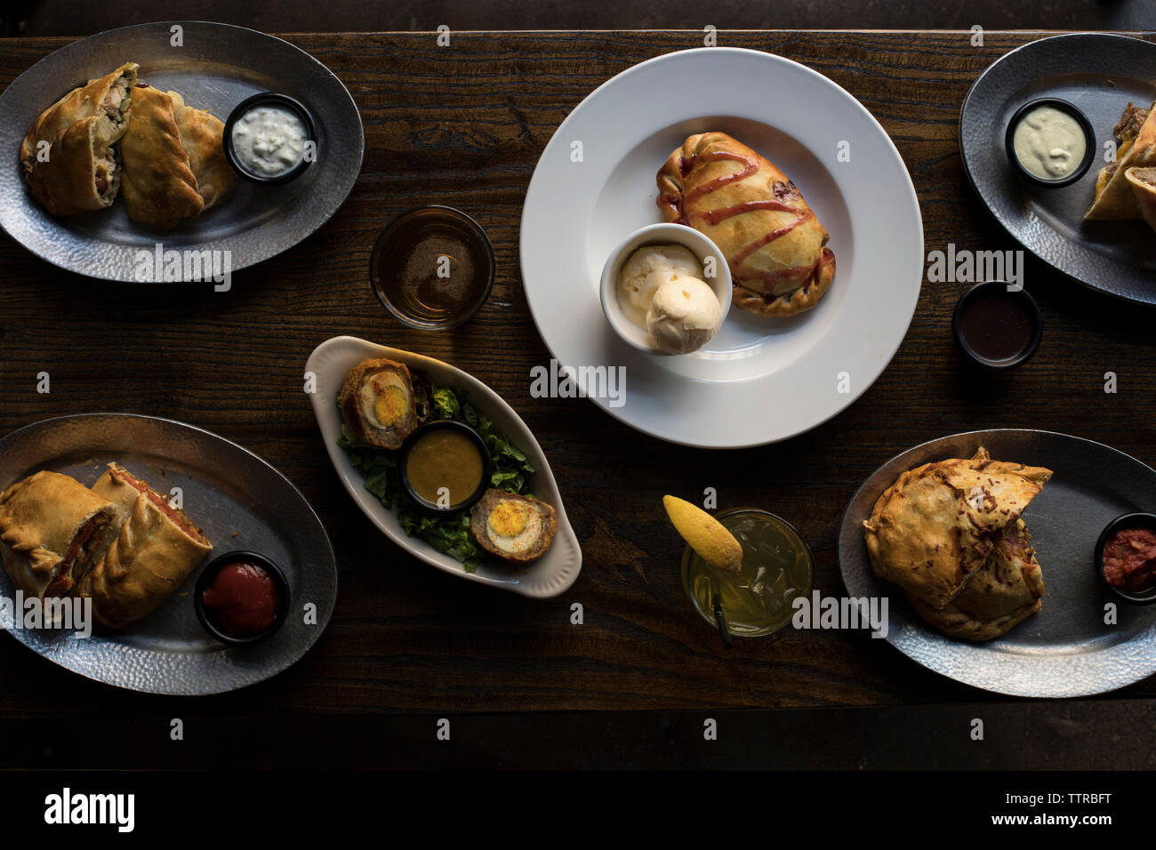 Overhead view of food in plates on dining table at restaurant Stock Photo