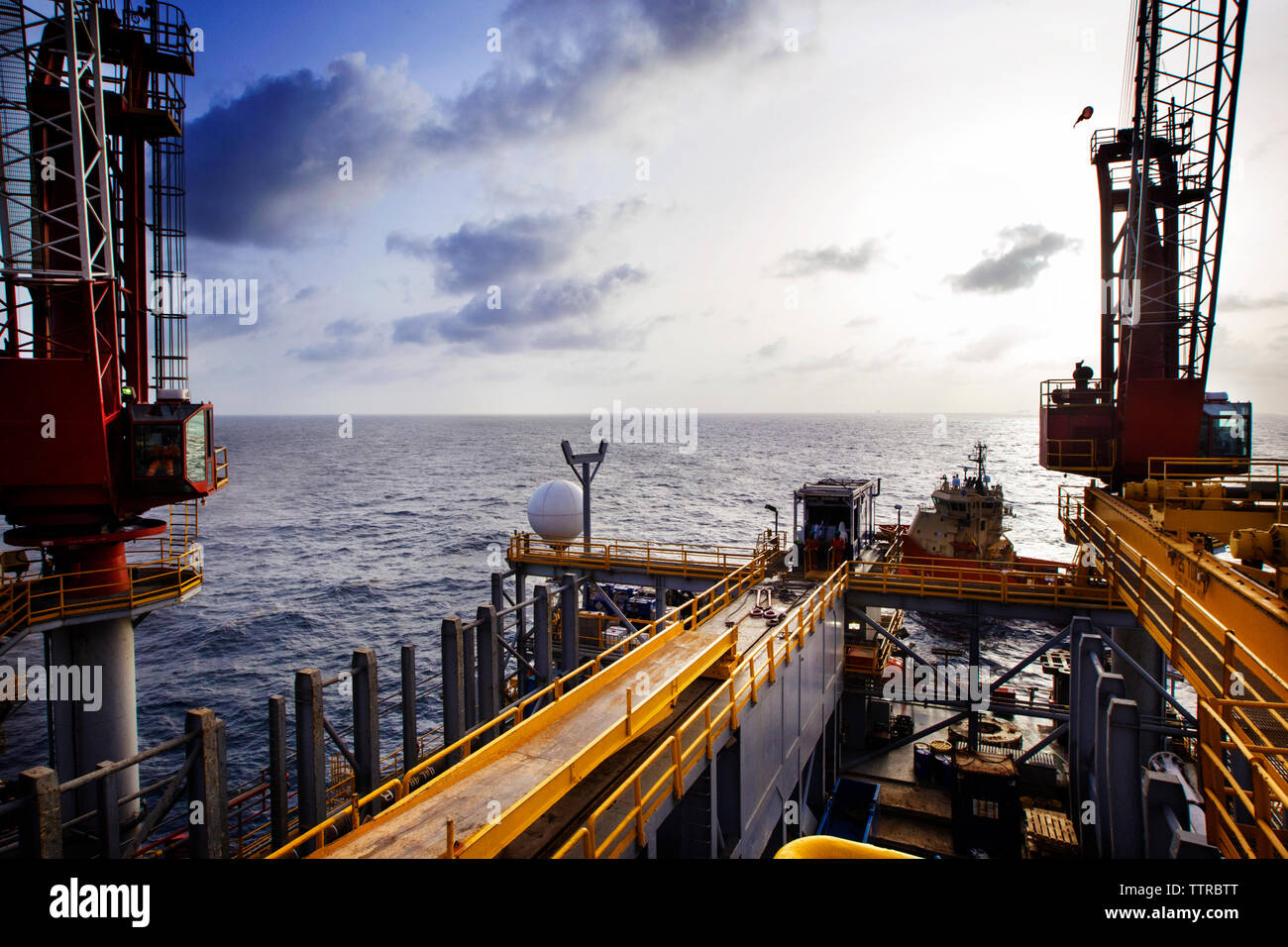 Offshore oil rig in sea against sky Stock Photo