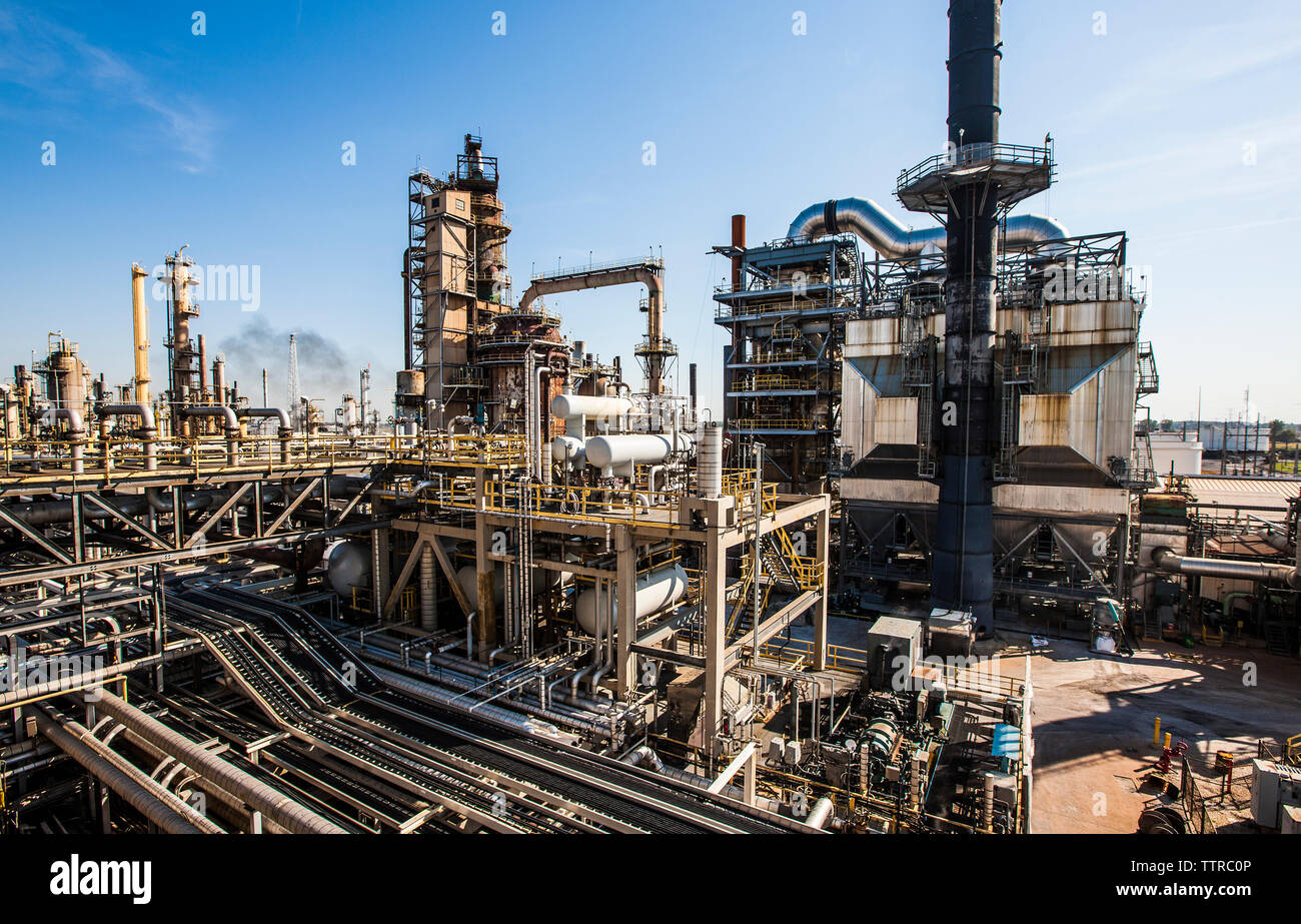 High angle view of oil refinery against blue sky during sunny day Stock ...
