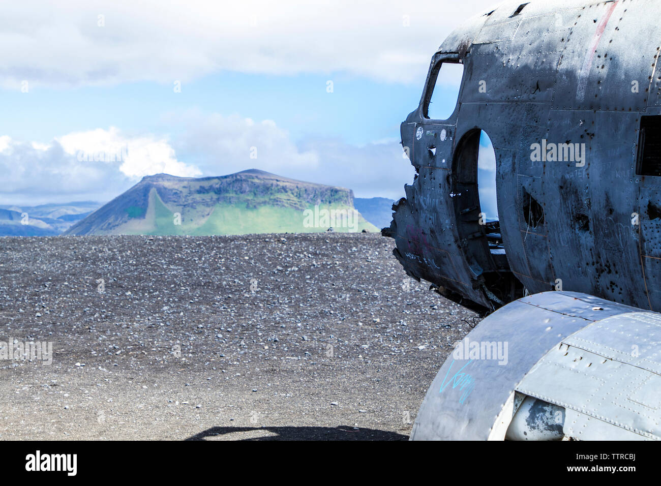 Close-up of airplane wreck against mountains Stock Photo