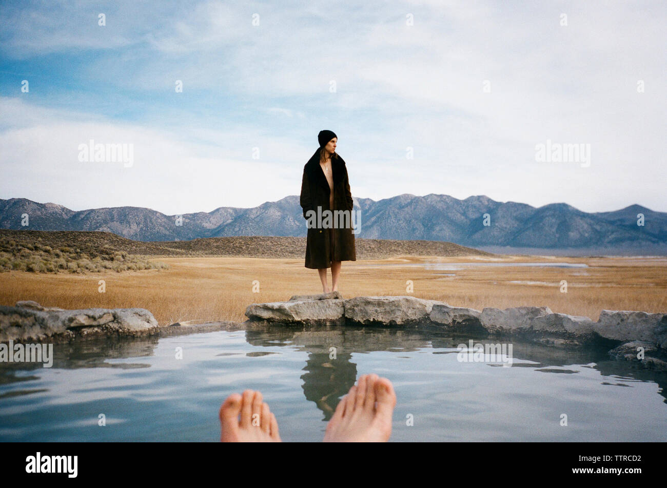 Woman looking away while standing on Mammoth Hot Springs against sky Stock Photo