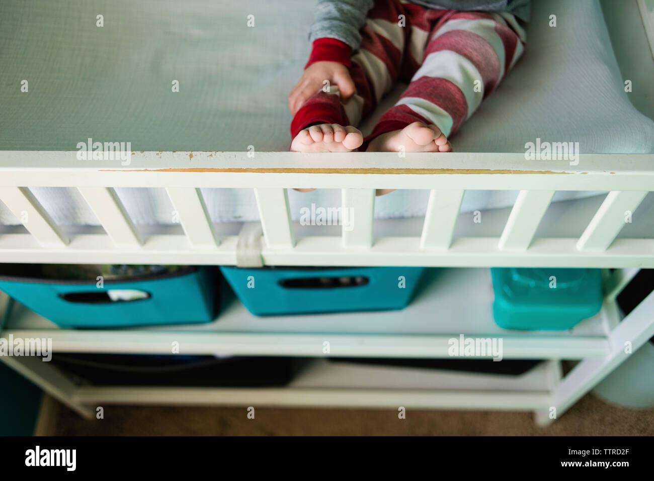 Low section of boy sitting on bunkbed Stock Photo