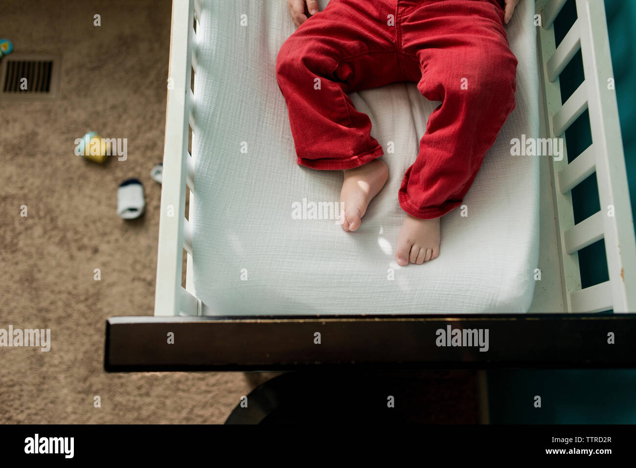 Low section of boy lying in bunkbed Stock Photo