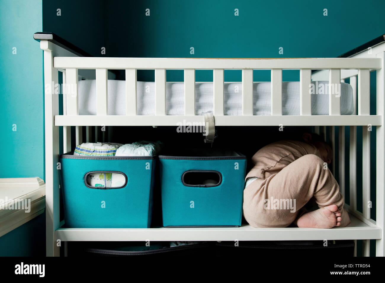 Playful boy hiding in bunkbed at home Stock Photo