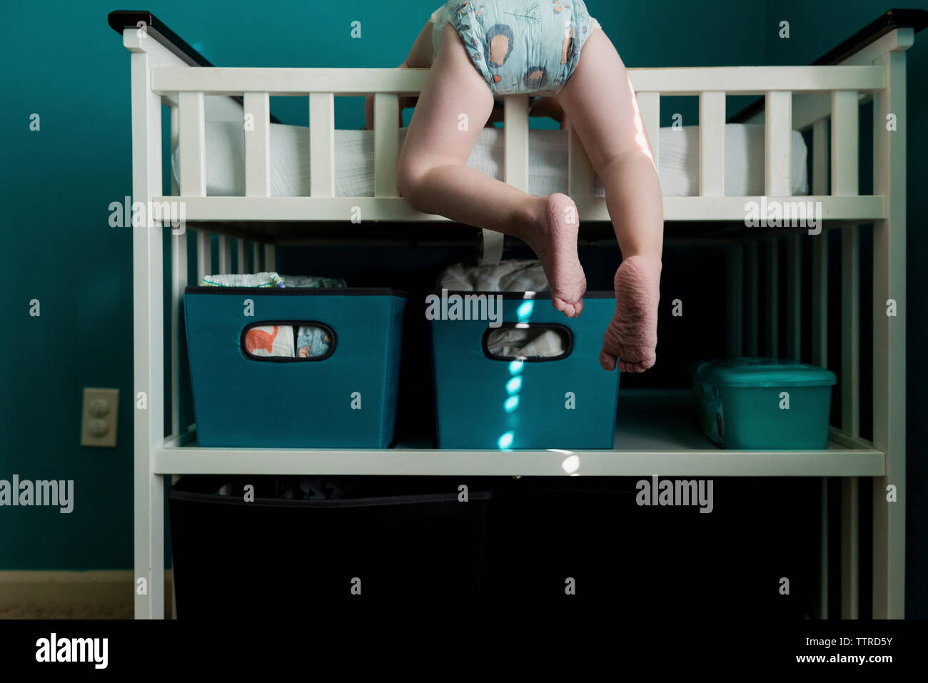 Low section of boy climbing bunkbed at home Stock Photo
