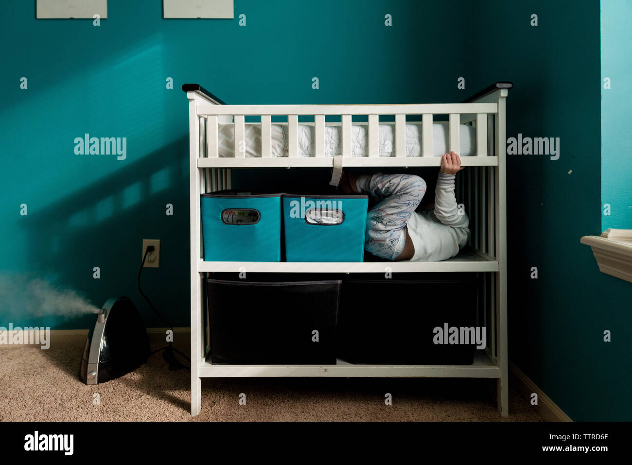 Boy hiding in bunkbed at home Stock Photo