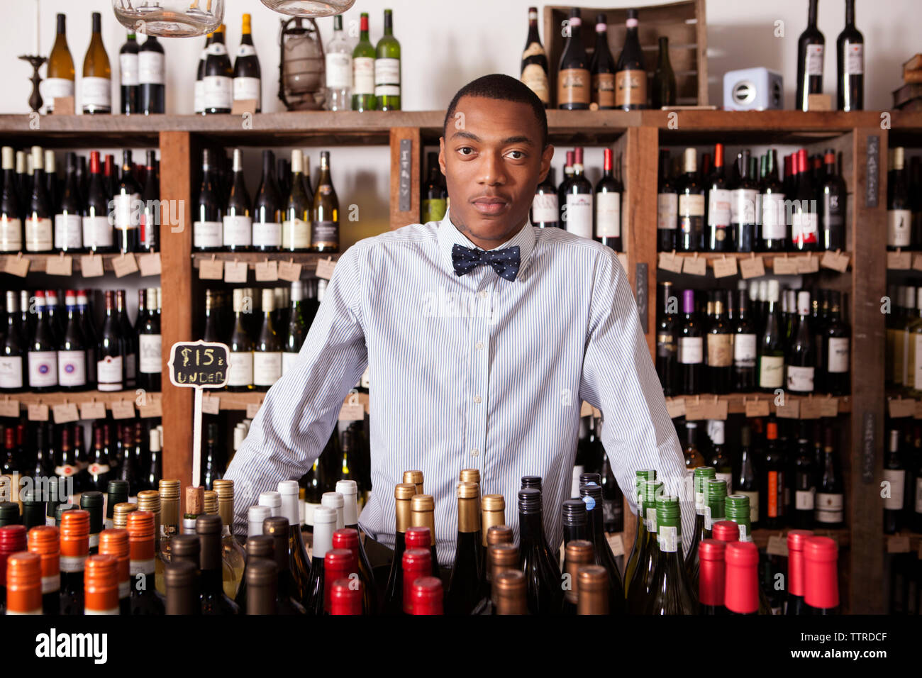 Portrait of confident male Small business owner standing in wine shop Stock Photo