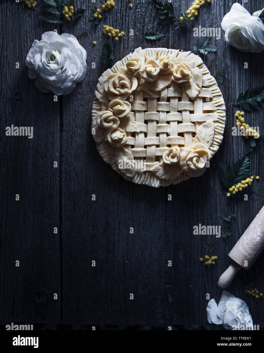 Overhead view of apple pie ready to bake placed on wooden table Stock Photo