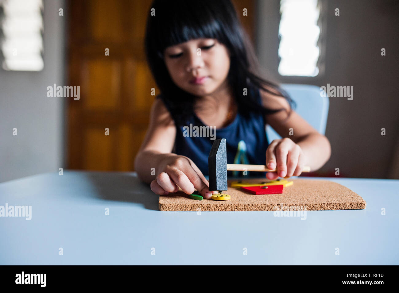 Boy making craftwork on cardboard at home Stock Photo