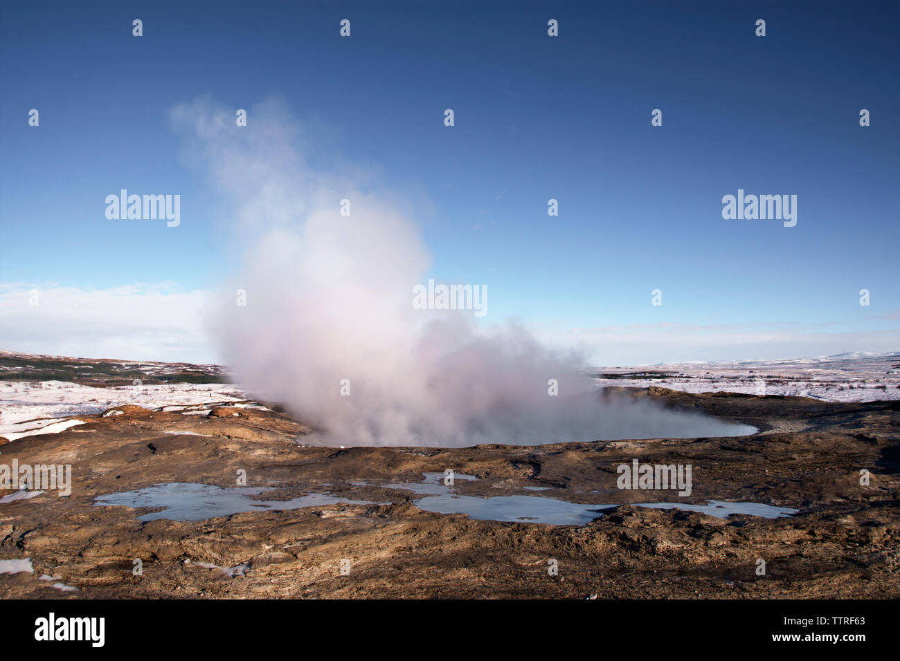 Steam coming out from geyser against clear blue sky Stock Photo