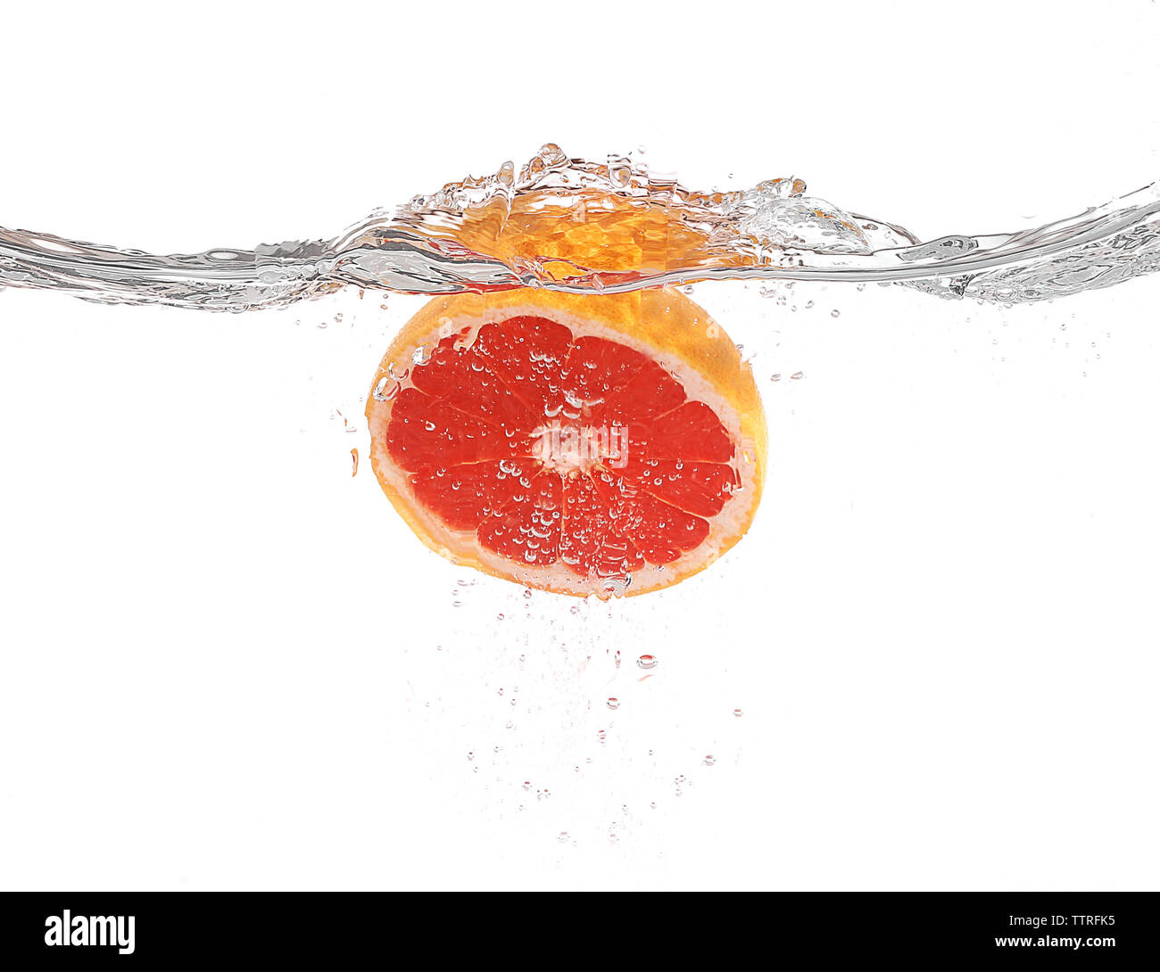 Grapefruit in water on white background Stock Photo - Alamy
