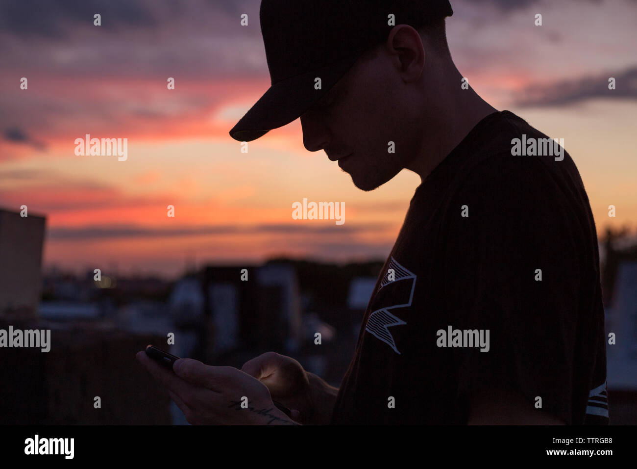 Close-up of silhouette man wearing cap Stock Photo