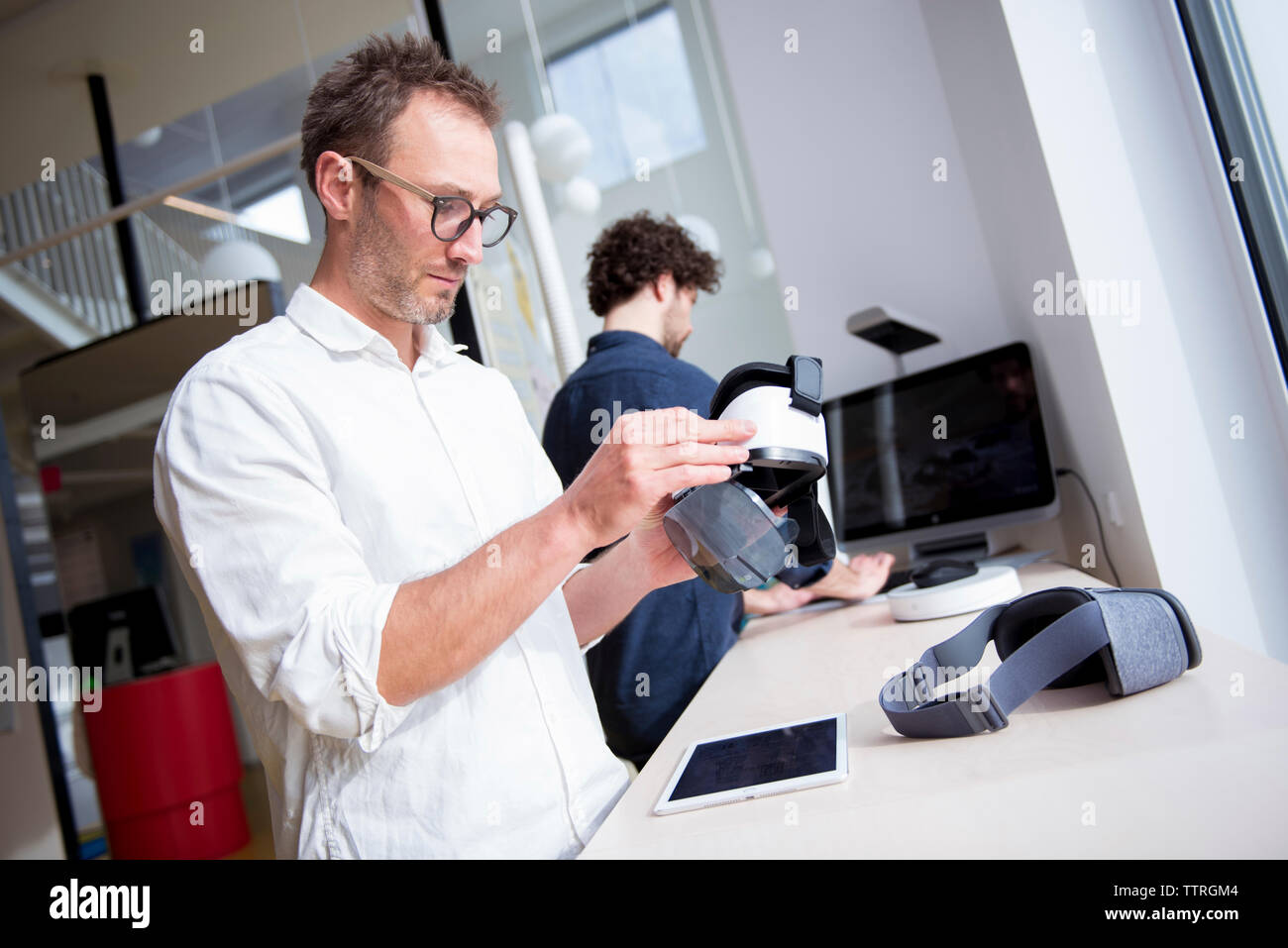 Male technicians working at table in office Stock Photo