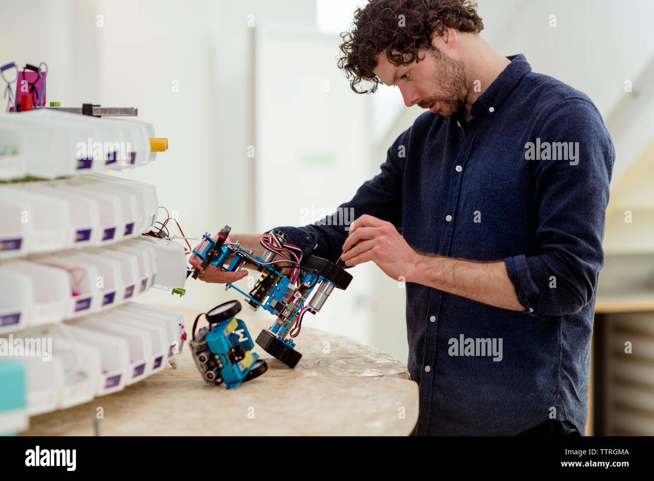 Engineer making drone at table in office Stock Photo