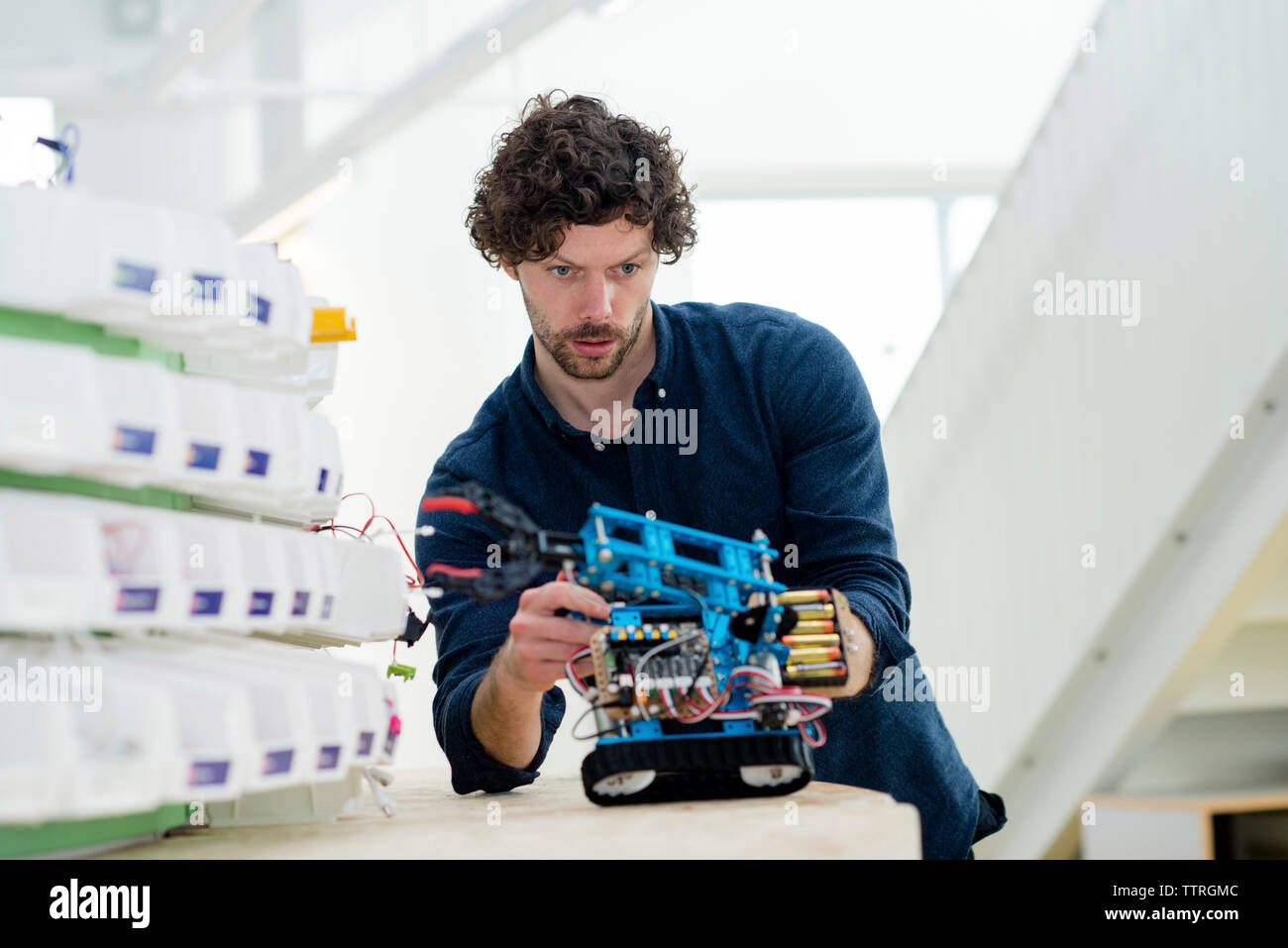 Low angle view of engineer making drone at table in office Stock Photo