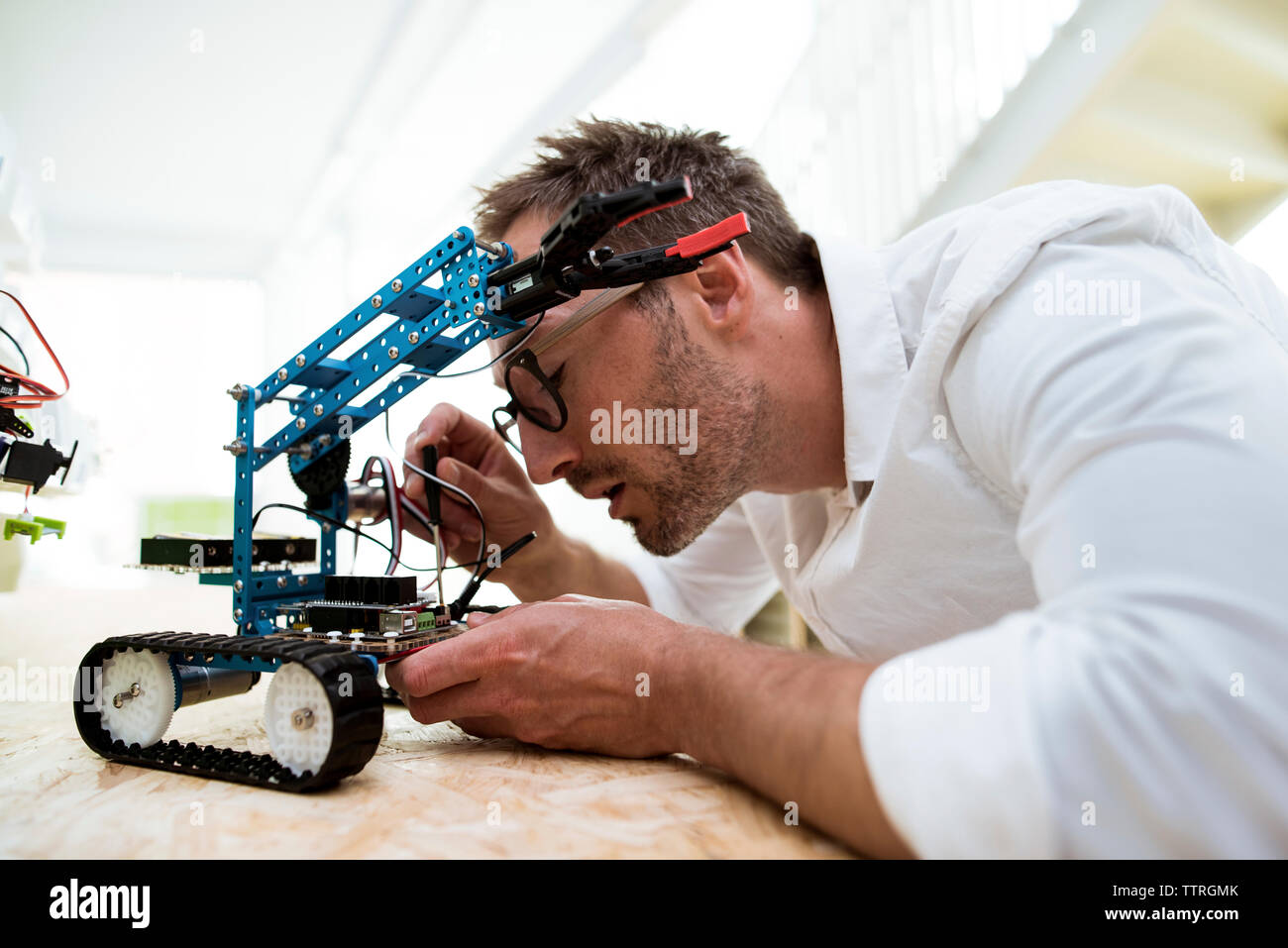 Engineer examining drone at table in office Stock Photo